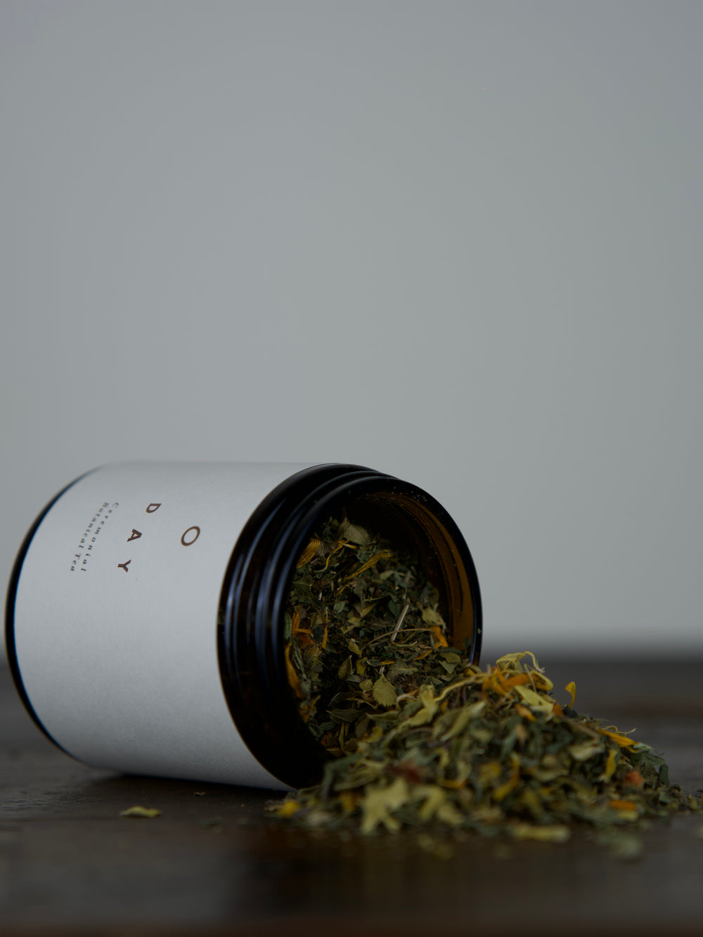 Herbal Tea in an amber glass jar spilling